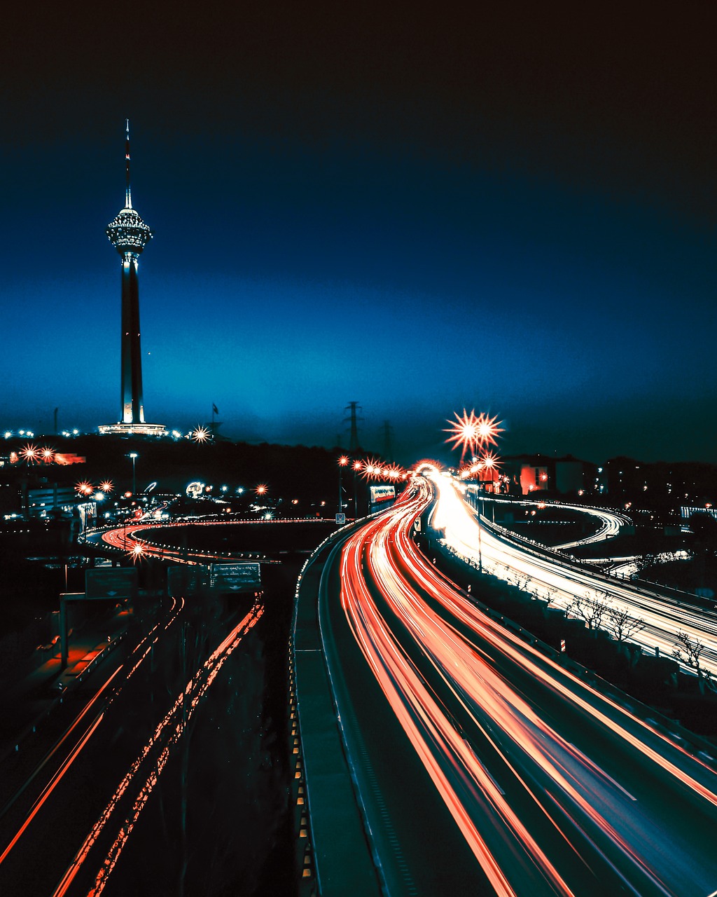 image of city highway at night with overexposed trails of vehicles - aggressive injury lawyer